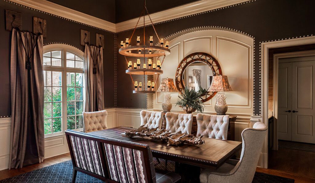 Living room of mansion with hardwood floors and library walls.